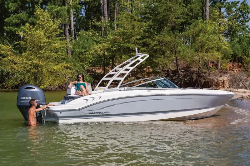 Slide: The Image of Manufacturer Provided Image: 2020 Chaparral 21 SSi OB boat in a scenic lake setting with people onboard. - 21