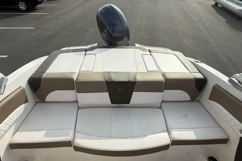 Slide: The Image of 2020 Chaparral 21 SSi OB boat interior with cushioned seating and outboard motor. - 6