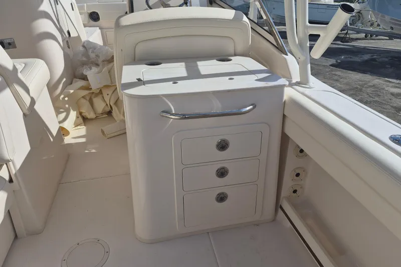 Slide: The Image of 2026 Grady-White Freedom 275 boat interior with storage drawers and seating. - 11