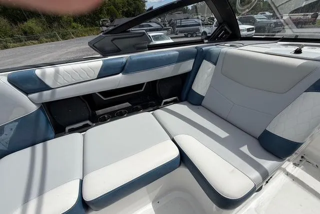 Slide: The Image of Interior of a 2021 Malibu M240 boat with blue and white seating. - 10