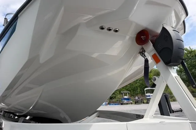 Slide: The Image of 2021 Malibu M240 boat on trailer, showcasing sleek hull design. - 17
