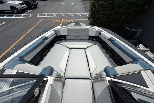 Slide: The Image of 2021 Malibu M240 boat interior with spacious seating and modern design. - 9