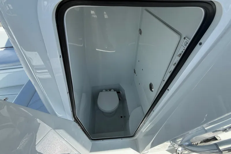 Slide: The Image of 2024 Contender 25 Tournament boat interior with compact marine toilet. - 10