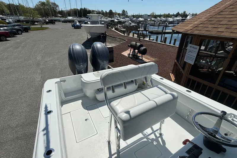 Slide: The Image of 2024 Contender 25 Tournament boat with dual engines docked at a marina. - 11