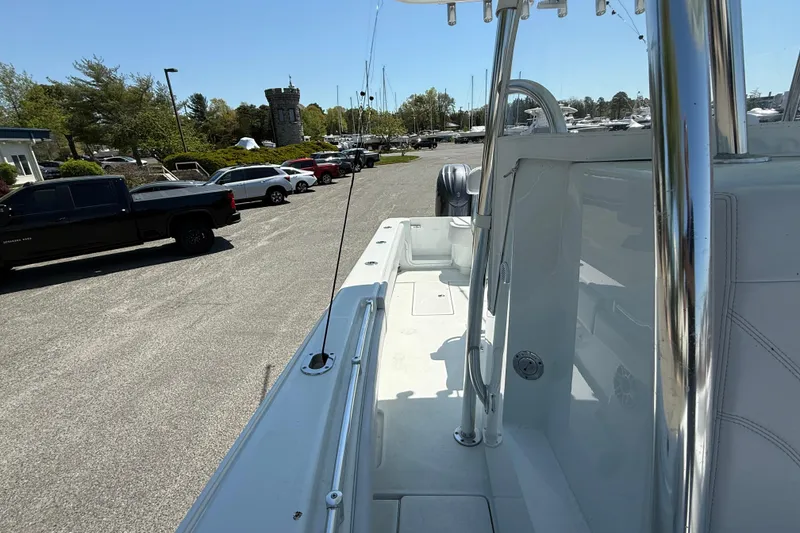 Slide: The Image of 2024 Contender 25 Tournament boat parked in a marina with surrounding vehicles. - 13