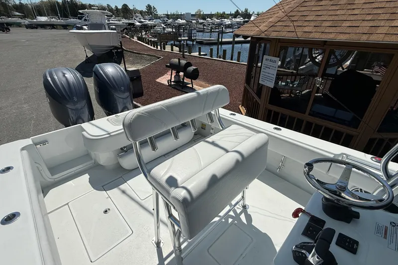 Slide: The Image of 2024 Contender 25 Tournament boat interior with dual engines at a marina. - 16