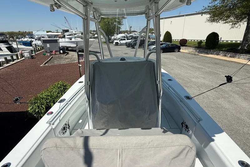 Slide: The Image of 2024 Contender 25 Tournament boat at marina, showcasing helm and seating area. - 20