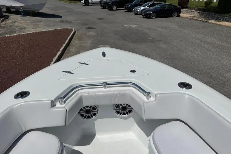Slide: The Image of 2024 Contender 25 Tournament boat bow with seating and speakers in a parking area. - 3
