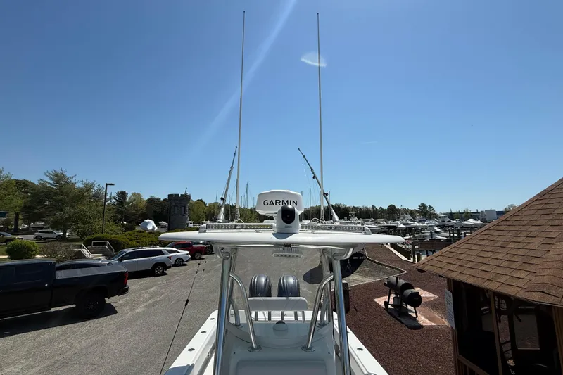 Slide: The Image of 2024 Contender 25 Tournament boat with Garmin equipment at a marina under clear blue sky. - 6