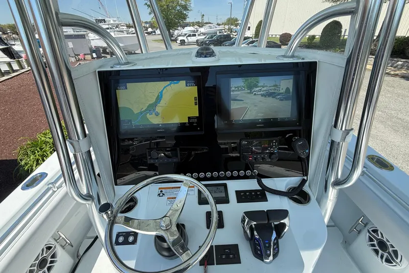Slide: The Image of 2024 Contender 25 Tournament boat dashboard with dual Garmin displays and steering wheel. - 7