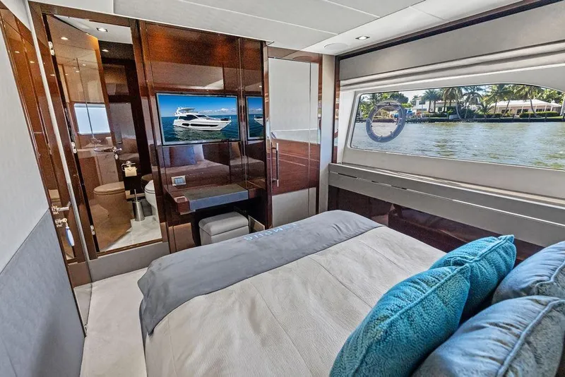 Slide: The Image of Luxurious 2019 Sunseeker 76 Yacht bedroom with waterfront view and modern amenities. - 26