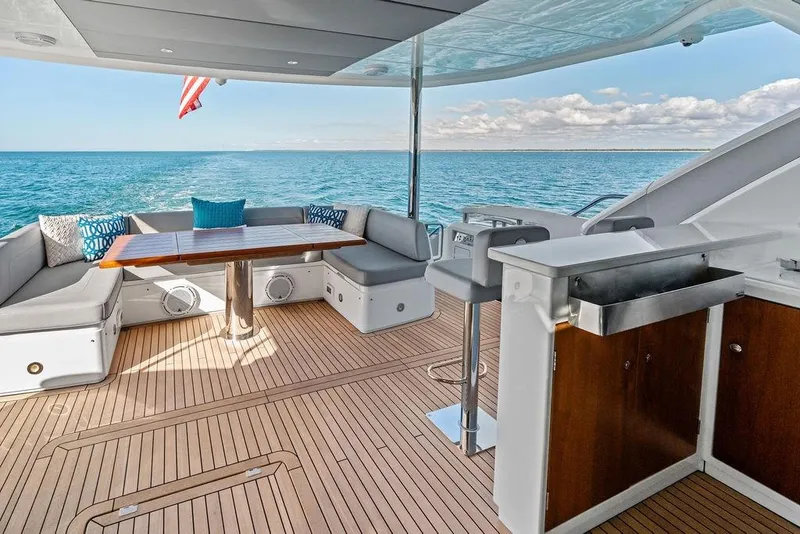 Slide: The Image of Luxurious 2019 Sunseeker 76 Yacht deck with seating, table, and ocean view. - 54