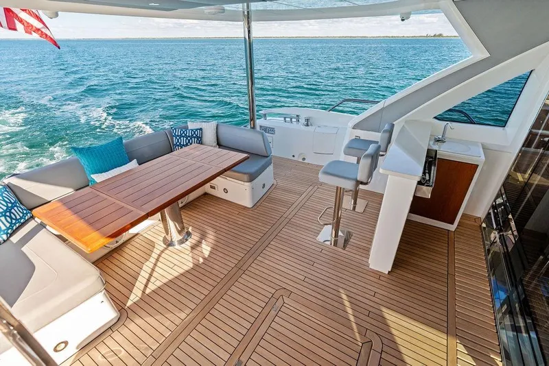 Slide: The Image of Luxurious 2019 Sunseeker 76 Yacht deck with seating, table, and ocean view. - 60