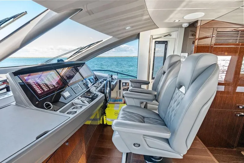 Slide: The Image of Luxurious 2019 Sunseeker 76 Yacht helm with modern controls and leather seating. - 64