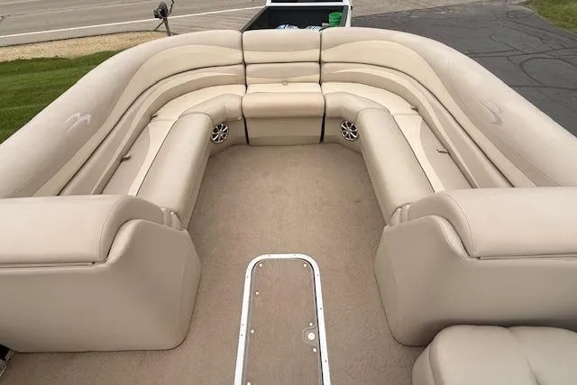 Slide: The Image of 2012 Bennington 2574 GCW boat interior with beige seating and carpeted floor. - 10
