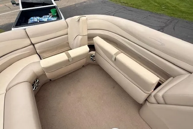 Slide: The Image of Luxurious seating on a 2012 Bennington 2574 GCW pontoon boat, featuring beige upholstery. - 11