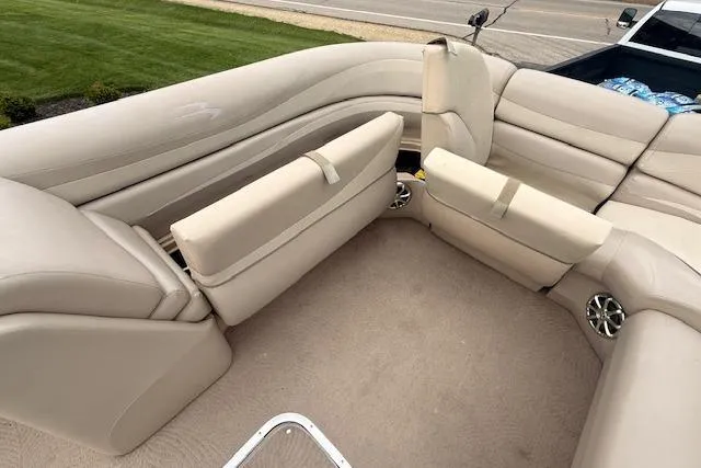 Slide: The Image of 2012 Bennington 2574 GCW boat interior with beige seating and carpeted floor. - 12