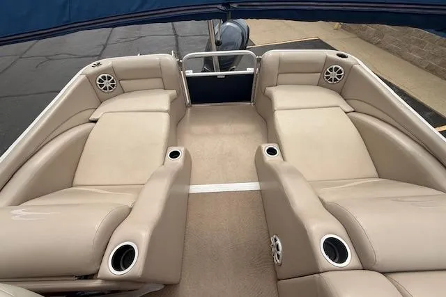 Slide: The Image of 2012 Bennington 2574 GCW boat interior with beige seating and cup holders. - 17