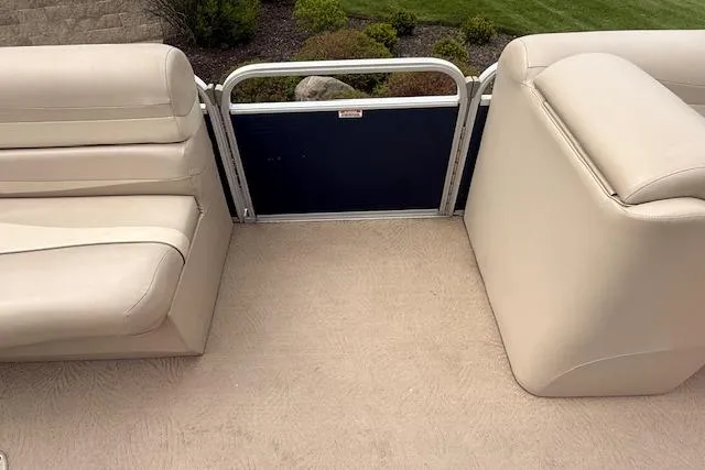Slide: The Image of 2012 Bennington 2574 GCW pontoon boat interior with beige seating and flooring. - 19