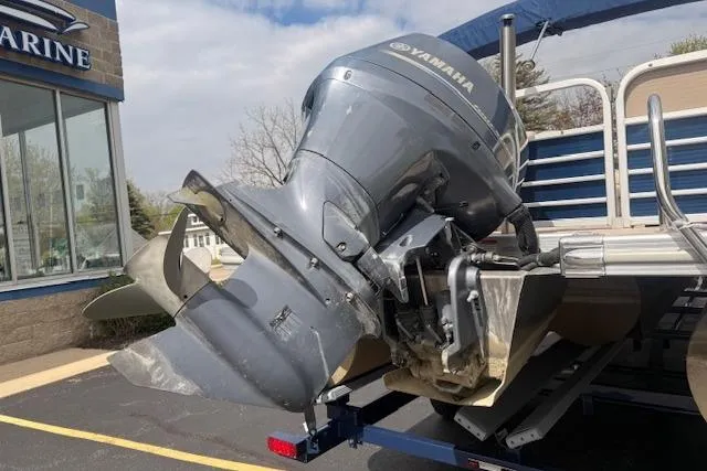 Slide: The Image of 2012 Bennington 2574 GCW boat with Yamaha outboard motor at a marine dealership. - 23