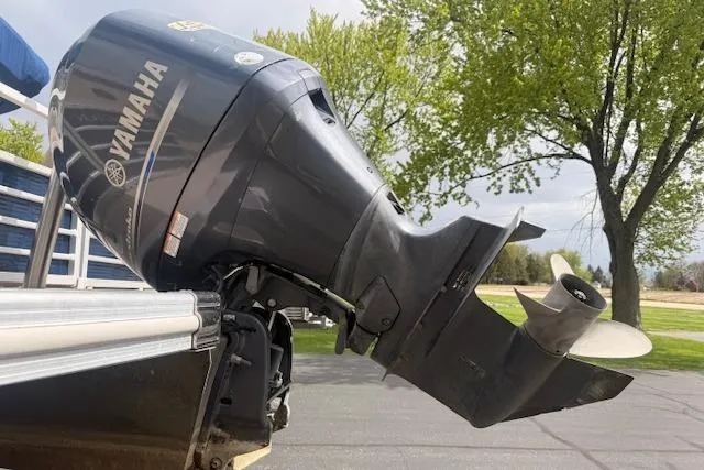Slide: The Image of Yamaha outboard motor on 2012 Bennington 2574 GCW boat, parked outdoors. - 24