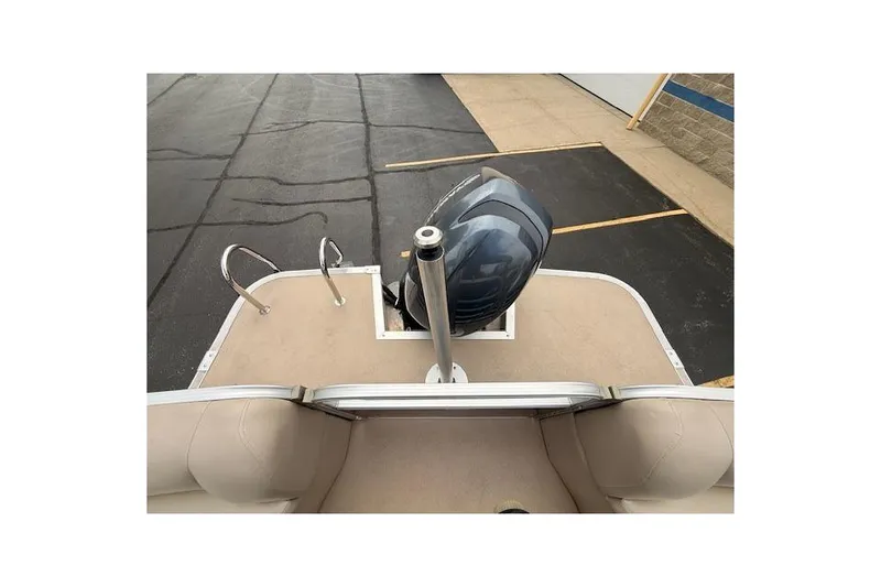Slide: The Image of 2012 Bennington 2574 GCW boat with motor and ladder on a paved surface. - 25