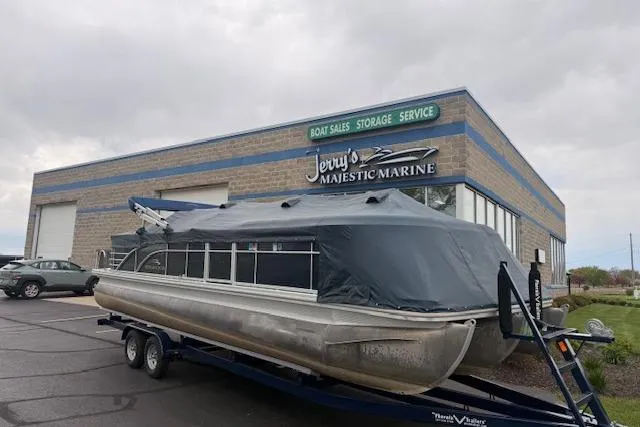 Slide: The Image of 2012 Bennington 2574 GCW pontoon boat covered, parked at Jerry's Majestic Marine. - 29