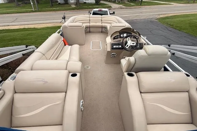 Slide: The Image of 2012 Bennington 2574 GCW pontoon boat with beige seating and steering console. - 3