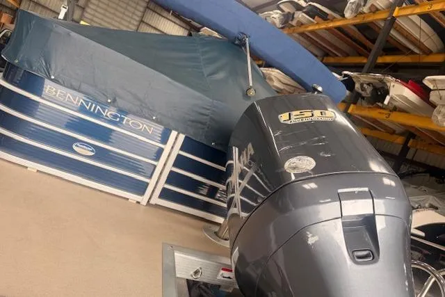 Slide: The Image of 2012 Bennington 2574 GCW pontoon boat with Yamaha 150 outboard motor in storage. - 31