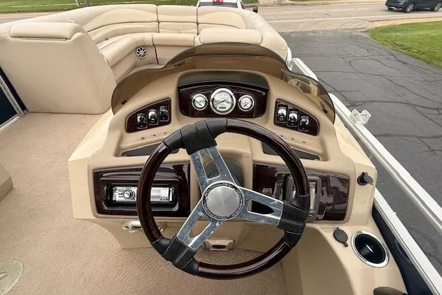Slide: The Image of 2012 Bennington 2574 GCW boat dashboard with steering wheel and control panel. - 6