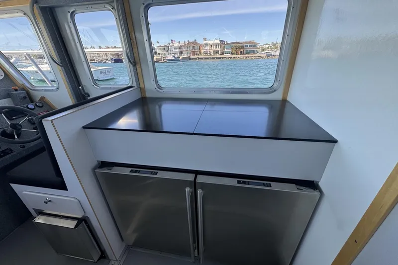 Slide: The Image of Interior of 2015 Armstrong Marine Power Cat with stainless steel appliances and ocean view. - 11
