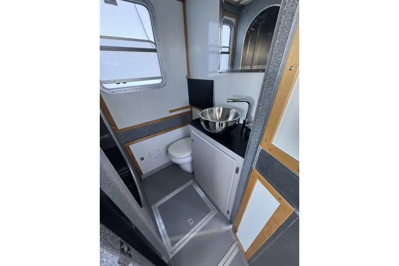Slide: The Image of Interior of 2015 Armstrong Marine Power Cat bathroom with sink and toilet. - 13