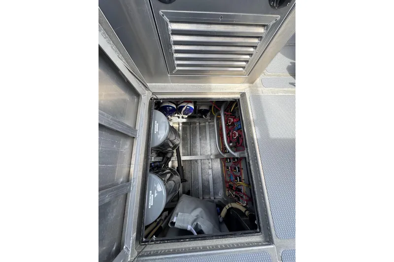 Slide: The Image of Engine compartment of a 2015 Armstrong Marine Power Cat, showcasing wiring and components. - 15