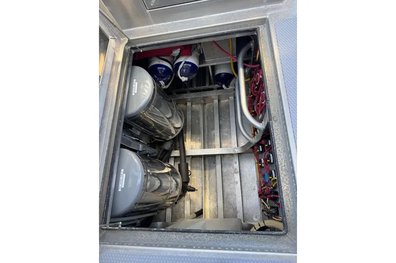 Slide: The Image of Engine compartment of a 2015 Armstrong Marine Power Cat, showcasing machinery and wiring. - 16