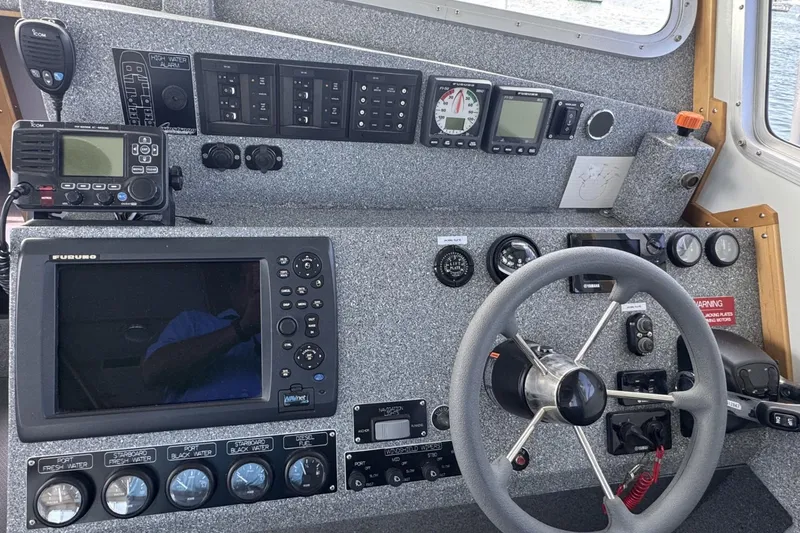Slide: The Image of Control panel of a 2015 Armstrong Marine Power Cat with navigation and communication equipment. - 7