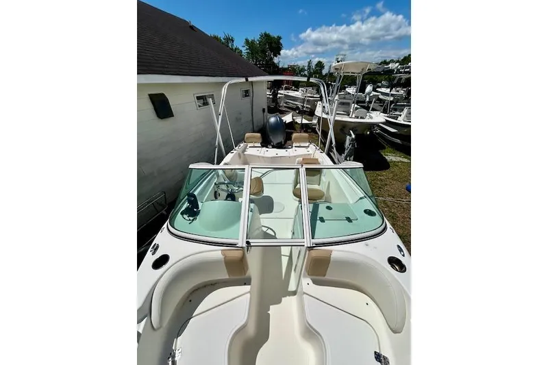 Slide: The Image of 2015 Pioneer 175 Venture boat with windshield, parked outdoors under blue sky. - 2