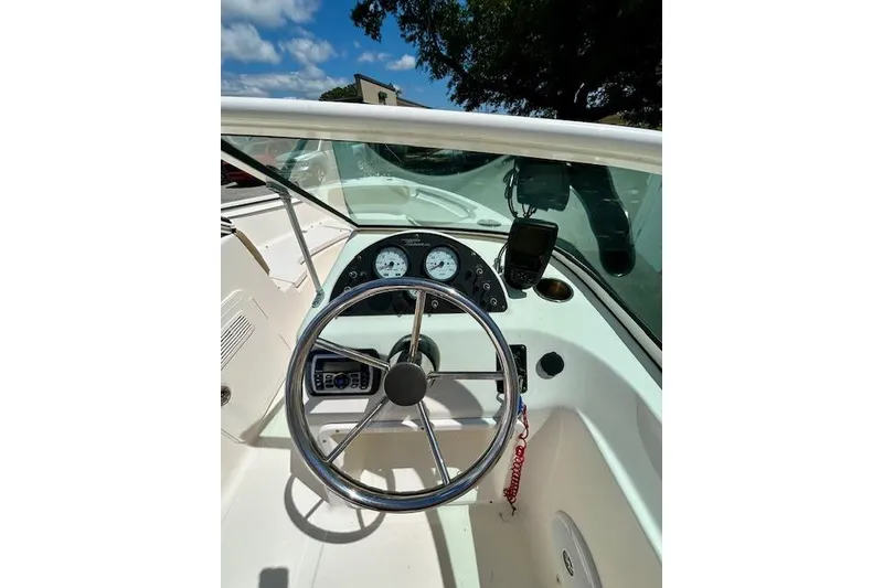 Slide: The Image of Steering console of a 2015 Pioneer 175 Venture boat under clear skies. - 5