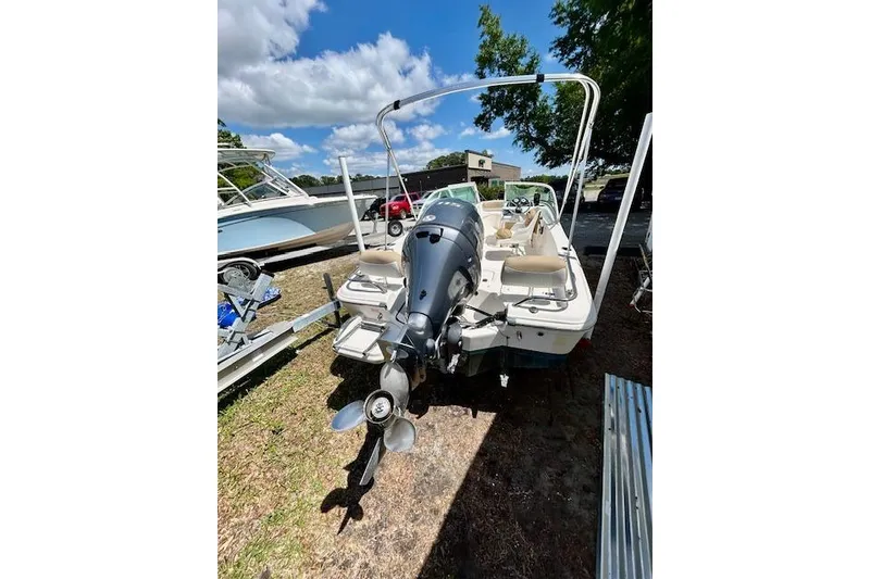 Slide: The Image of 2015 Pioneer 175 Venture boat with outboard motor, parked outdoors under a blue sky. - 7
