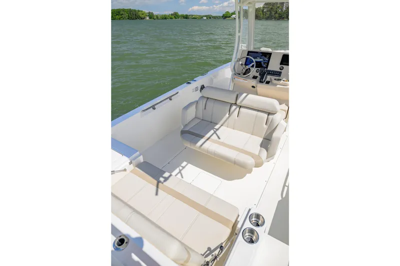 Slide: The Image of 2023 Boston Whaler 280 Dauntless boat interior with seating and steering console. - 10