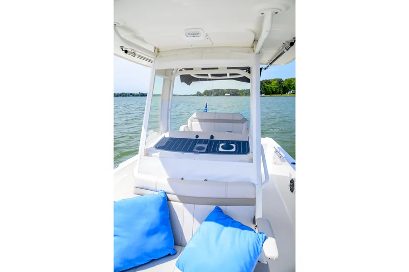 Slide: The Image of 2023 Boston Whaler 280 Dauntless boat interior with blue cushions on a sunny day. - 12