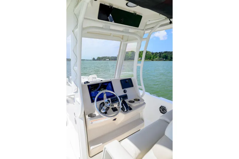 Slide: The Image of Interior view of 2023 Boston Whaler 280 Dauntless boat cockpit with steering wheel and controls. - 14