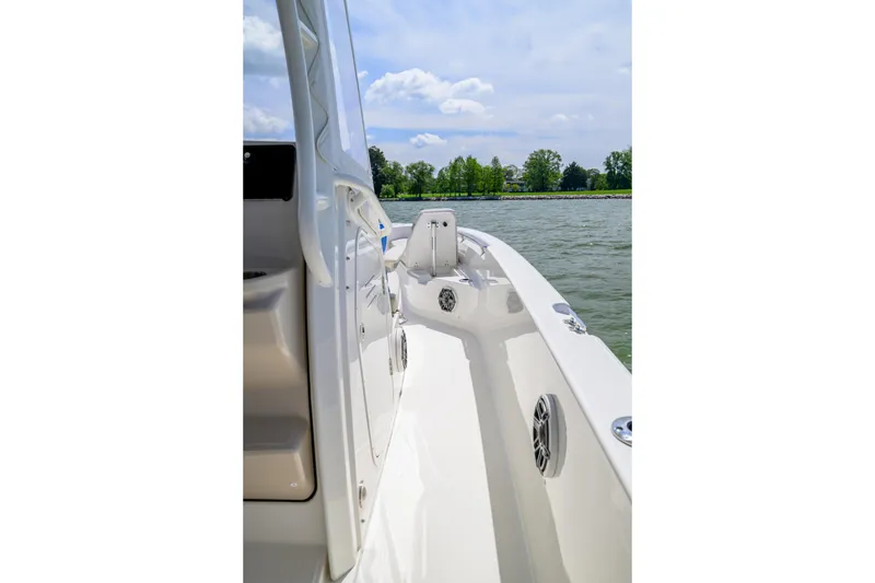 Slide: The Image of 2023 Boston Whaler 280 Dauntless boat deck, cruising on a scenic lake. - 20