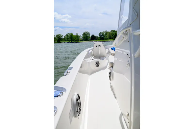 Slide: The Image of 2023 Boston Whaler 280 Dauntless boat deck, cruising on a calm lake under a clear sky. - 21