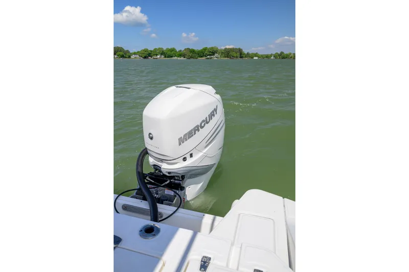 Slide: The Image of 2023 Boston Whaler 280 Dauntless with Mercury outboard engine on a lake. - 22