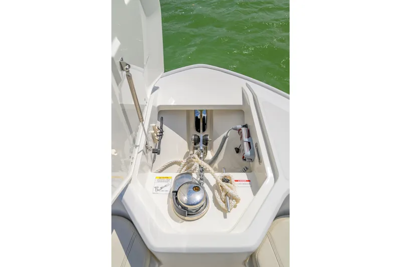 Slide: The Image of Anchor compartment of 2023 Boston Whaler 280 Dauntless boat, open with ropes and equipment. - 25