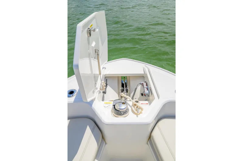 Slide: The Image of 2023 Boston Whaler 280 Dauntless boat anchor compartment open on calm water. - 27