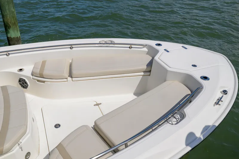 Slide: The Image of 2023 Boston Whaler 280 Dauntless boat interior with cushioned seating and stainless steel railings. - 29