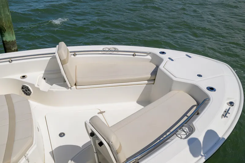 Slide: The Image of 2023 Boston Whaler 280 Dauntless boat interior with cushioned seating and ocean view. - 30