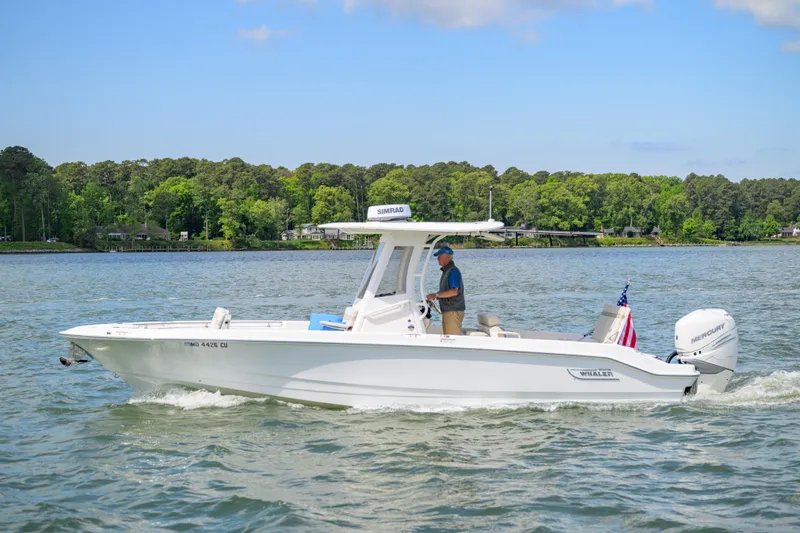Slide: The Image of 2023 Boston Whaler 280 Dauntless boat cruising on a scenic lake. - 4