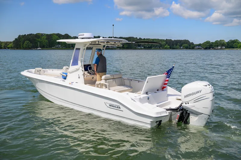 Slide: The Image of 2023 Boston Whaler 280 Dauntless boat on water, featuring Mercury engine and American flag. - 5